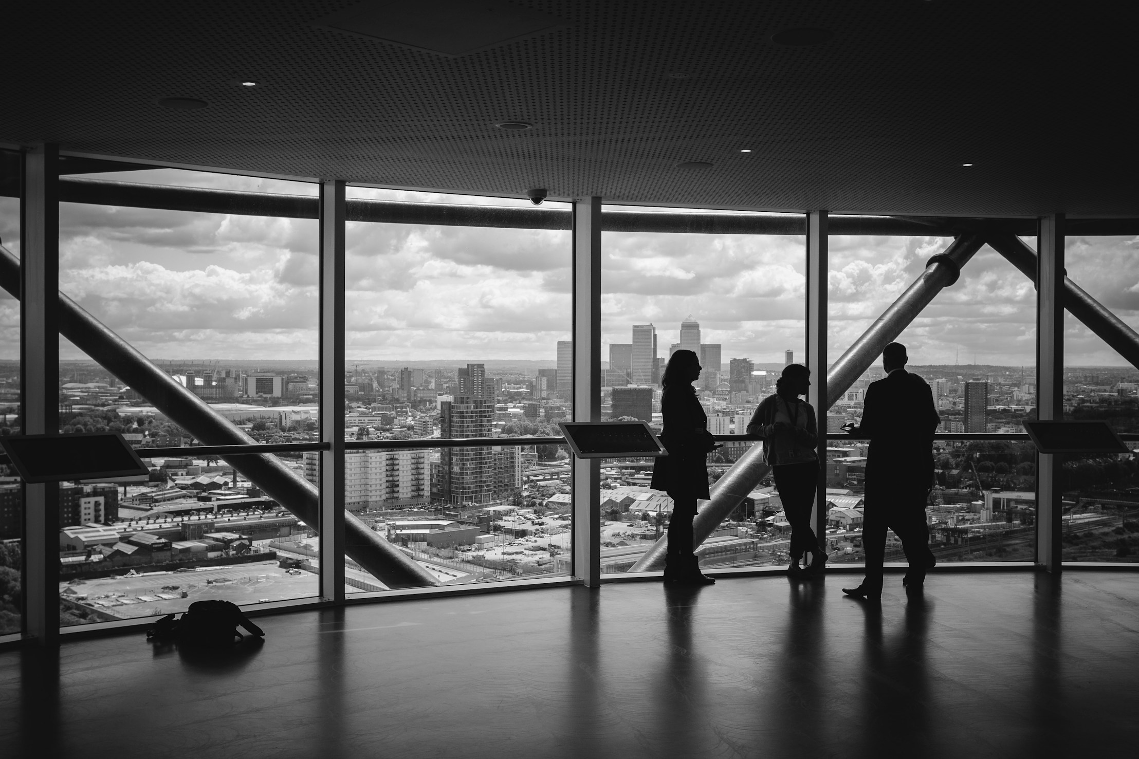 People chatting in a high‑rise office with a city view
