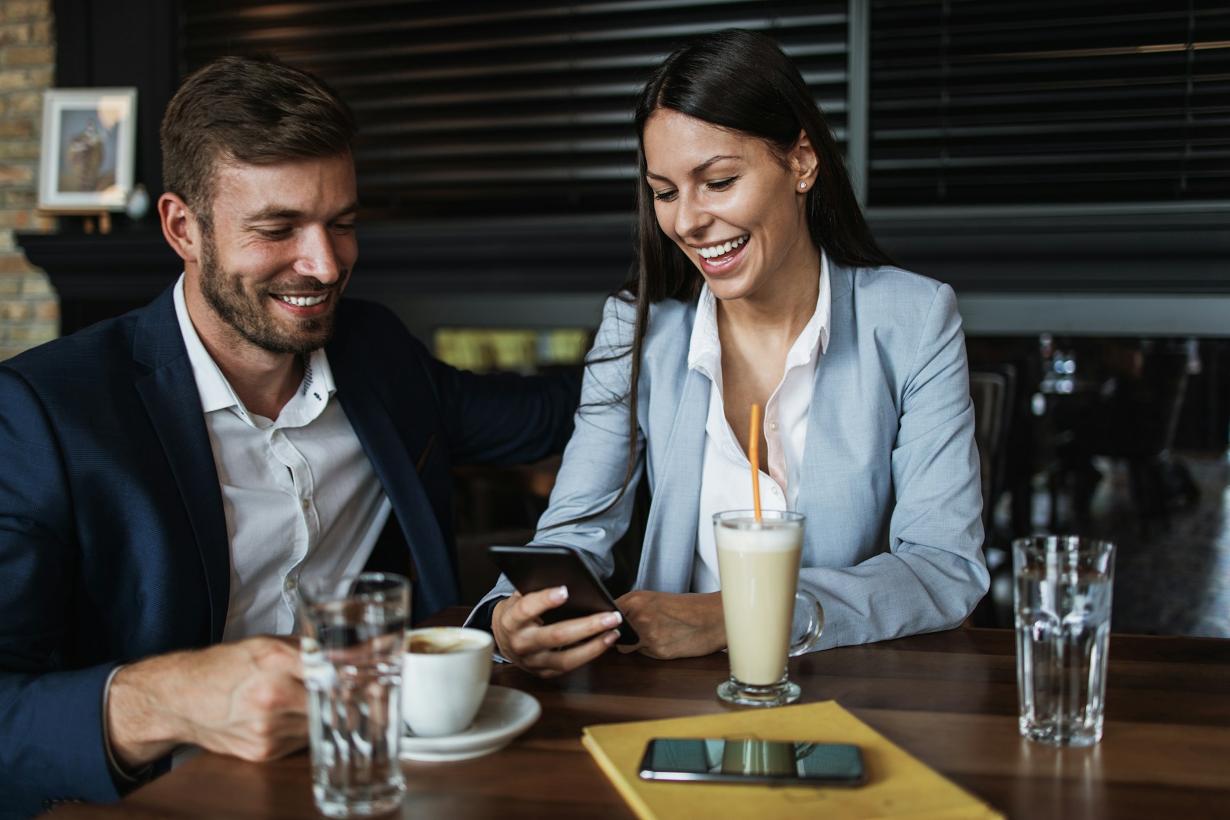 Two people discussing over coffee