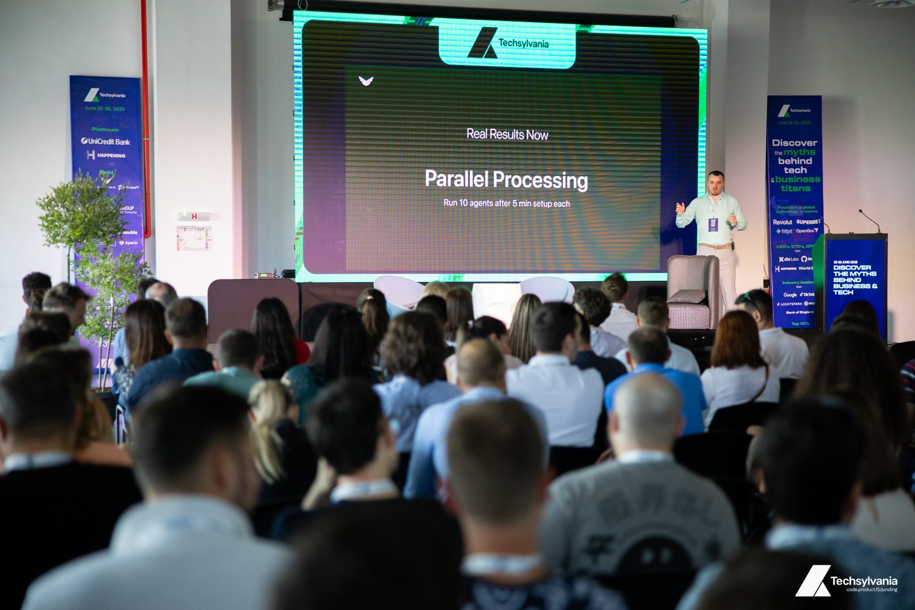 Andrei Hasna speaking on stage at Techsylvania 2025
