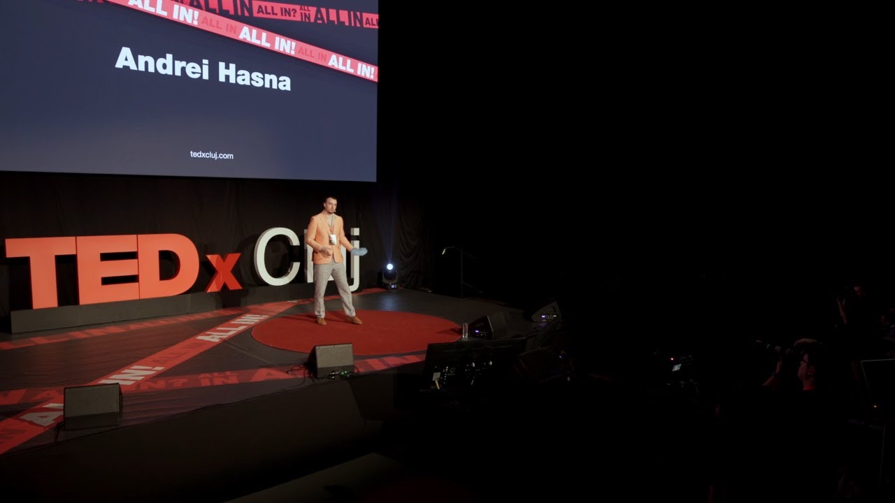 Andrei Hasna on stage giving his TEDxCluj 2024 talk, Improvise, adapt, overcome